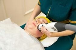 Woman receiving laser skin treatment
